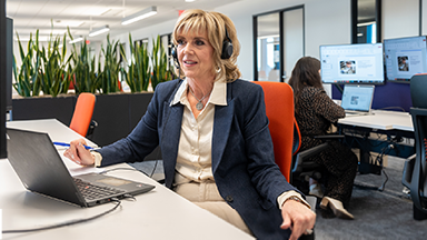 A HemAssist team member sitting in front of her computer at her desk