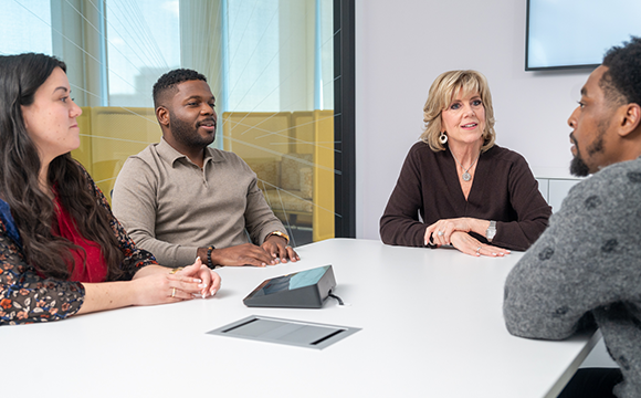 HemAssist team members sitting in a conference room having a meeting